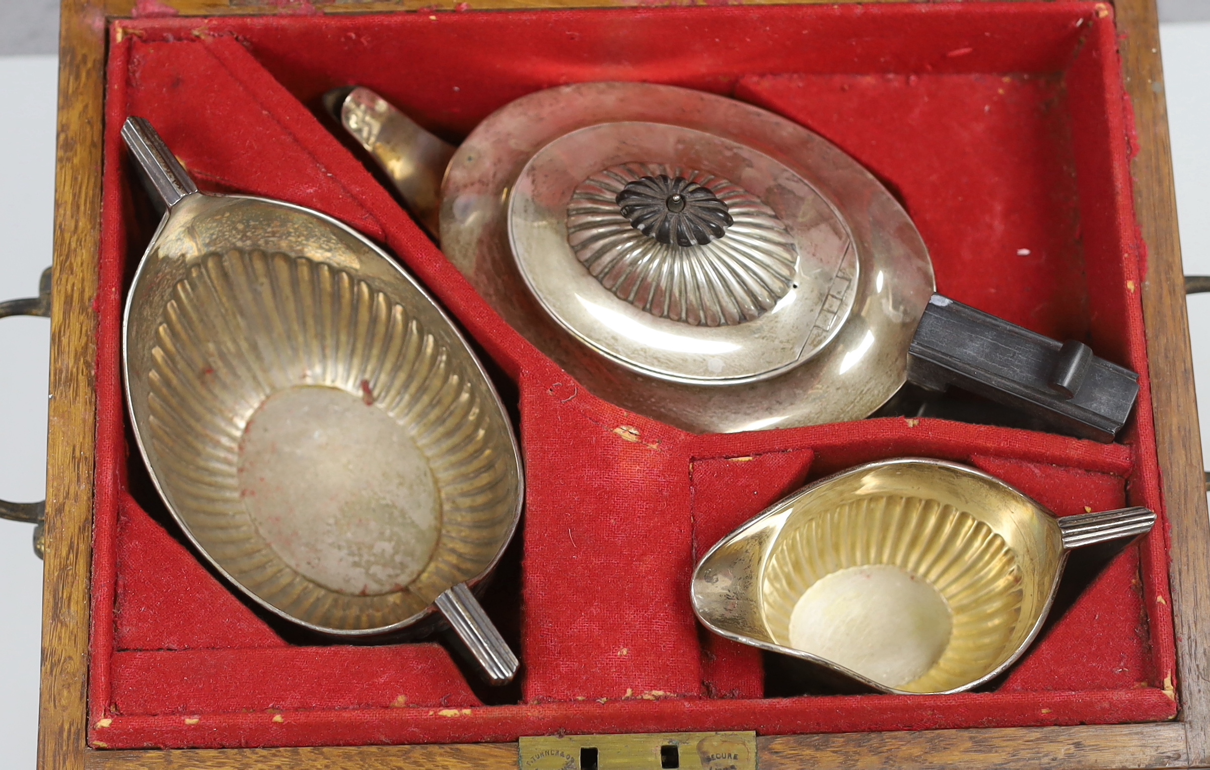A Victorian demi-fluted oval silver three piece tea set by William & John Barnard, London, 1886, gross weight 30.5oz, in fitted oak two handled box.